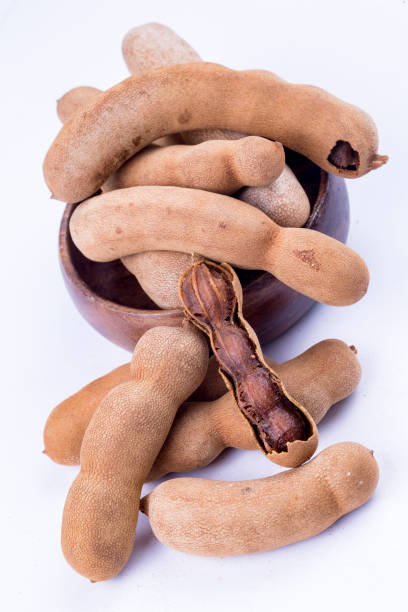 istock Dried tamarind fruits isolated on a white background 1067117578