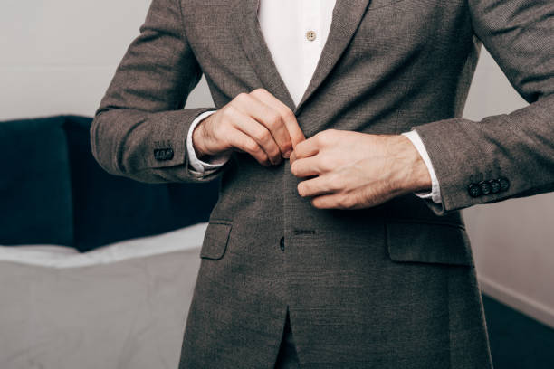 istock cropped image of businessman buttoning up jacket 1067117684
