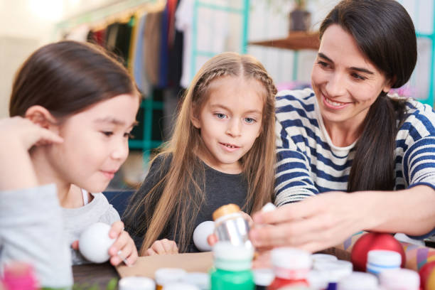 istock Two Children Making Christmas Decorations 1067120078