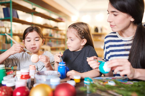 istock Little Girls  Making Handmade Ornaments 1067120102