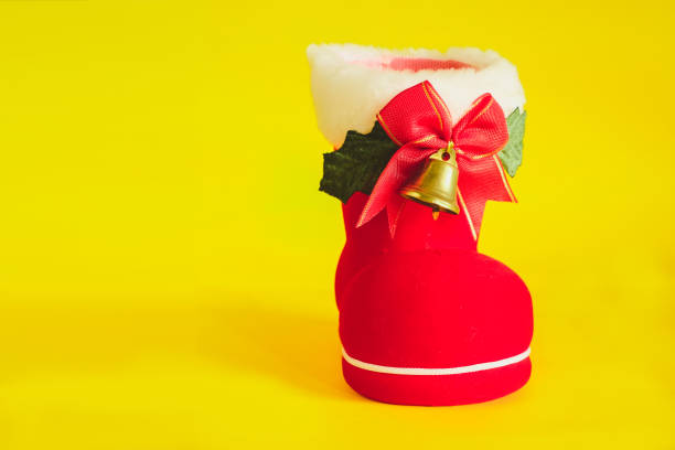 istock Red Christmas boot with gift on color background. 1067126270