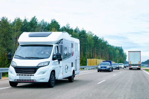 a motorhome moves along a scenic road