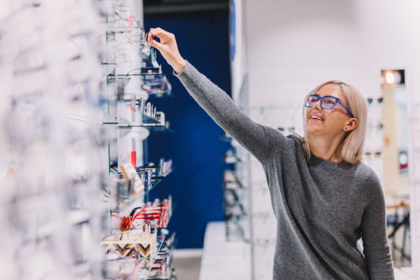 istock Woman choosing glasses at optic store. 1067130434