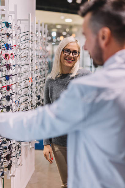 istock Woman and optician choosing glasses 1067130436