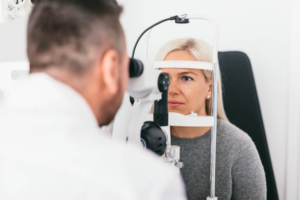 istock Woman undergoing eyesight exam in optician's office. 1067130482