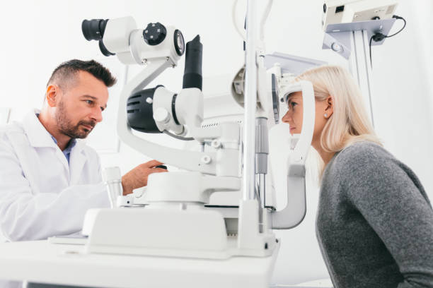 istock Optician checking woman's eyes with special equipment. 1067130492