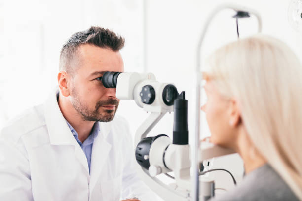 istock Optician examining his patients eyesight. 1067130498