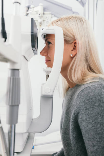 istock Woman taking eyesight test at optician's office. 1067130570