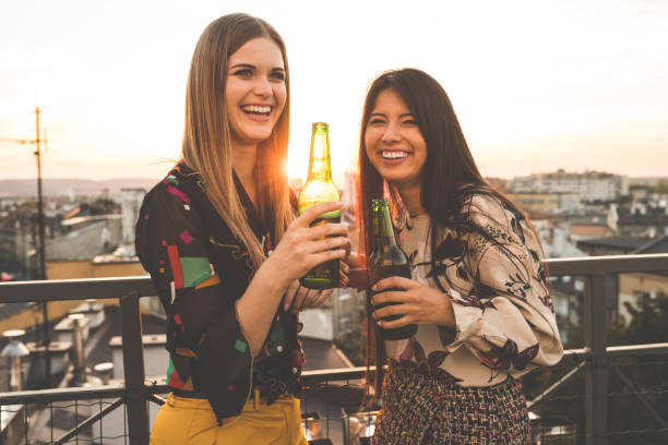 istock Beautiful women having beers at party 1067130752
