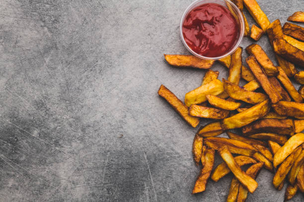 istock French fries with ketchup on grey table 1067130814