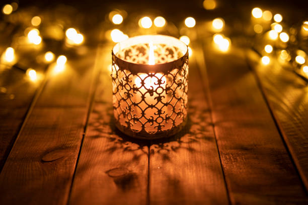 istock Tea light on a wooden table with baubles 1067130936