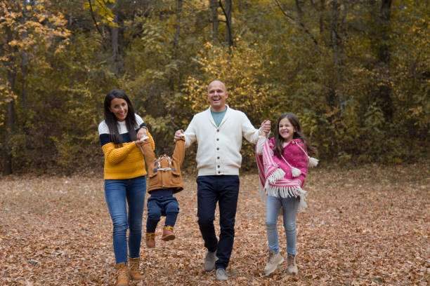 istock Young happy family having fun in public park 1067132362