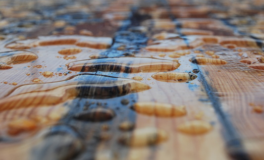 Large water drops on a wooden table