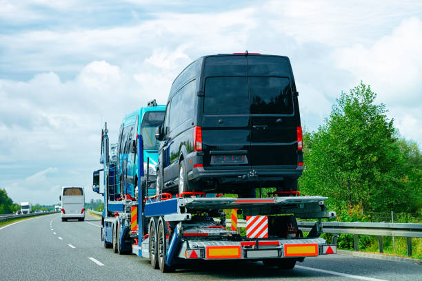 camionista con mini van in strada in slovenia - car car transporter carrying transportation foto e immagini stock