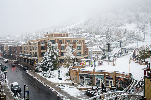 Park city,Utah USA - October 10, 2018 : Early Autumn snow storm in a street shot of Park City Utah. Park City was a small mining town in 1800's . Now it is one of the best ski resort town in Utah. Also known for the Sundance Film Festival in every January. Bus trollies go up and down Main Street and provides free public transportation to everyone.
