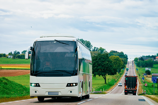 White Tourist bus on the road, Poland. Travel concept.