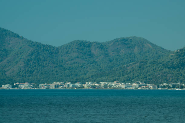 Nature landscape with a city by the shore of the sea between the hills. mountain town panoramic view
