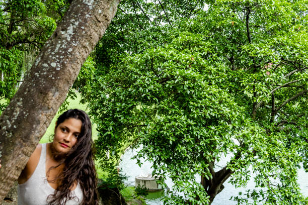 istock Woman leaning against tree 1067137160