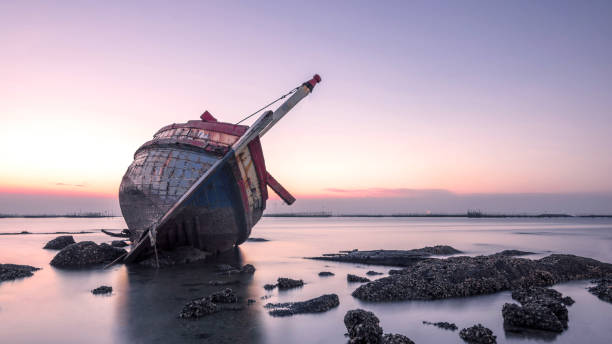 beautiful sunset  ,boat crashes in the sea , landscape  Thailand beautiful sunset  ,boat crashes in the sea , landscape  Thailand fishing boat sinking stock pictures, royalty-free photos & images