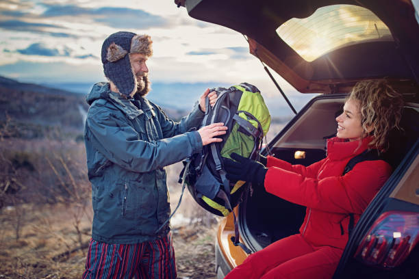 istock Hiking couple is resting and loading their backpacks after long trekking in mountain 1067144548