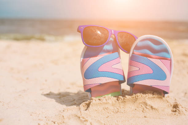 istock Handsome young man lying in a hammock at a sunny beach by an ocean 1067146392