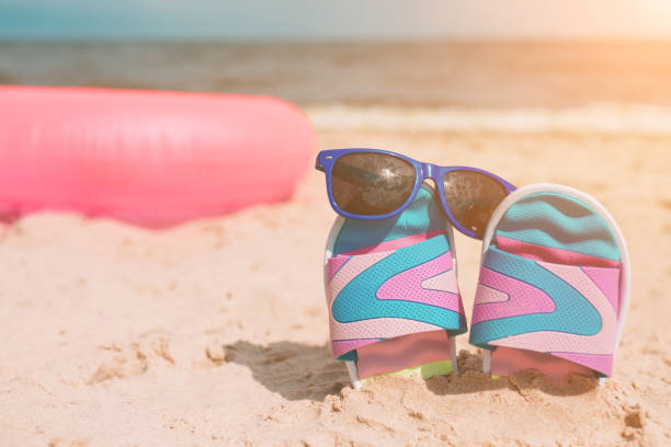 istock Handsome young man lying in a hammock at a sunny beach by an ocean 1067146406