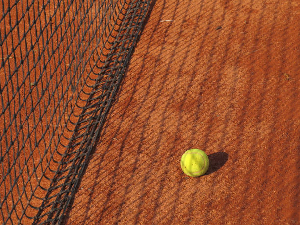 istock tennis ball and net 1067147018