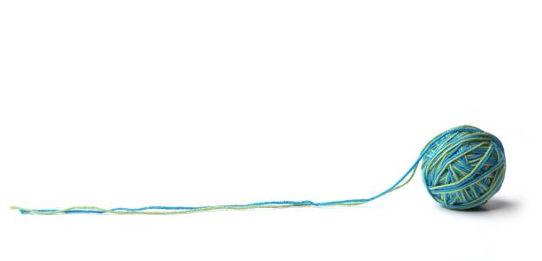 istock Colorful cotton thread ball from two color green and blue thread  isolated on white background. 1067147900
