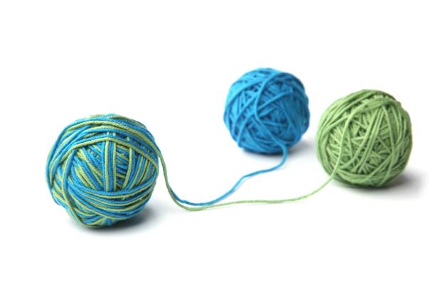 istock Colorful cotton thread ball from two color green and blue thread isolated on white background. 1067147926