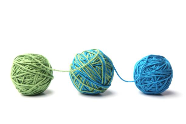 istock Colorful cotton thread ball from two color green and blue thread isolated on white background. 1067148966
