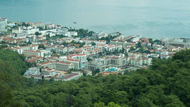 istock Mountain town panoramic view. city between the hills with the sea 1067152010