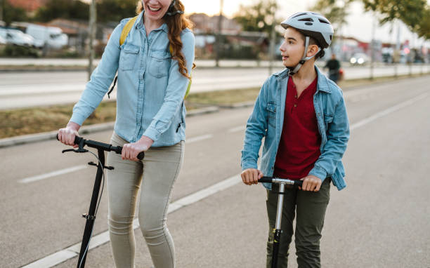 istock Boy with his mother riding a scooter 1067152992