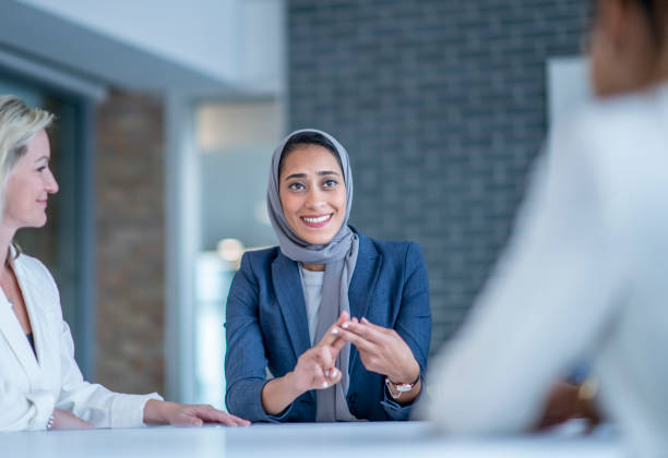 istock Muslim woman smiling at employees 1067159398