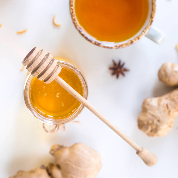 istock Tea with turmeric among products for improving immunity and treating colds - ginger, lemon and a jar of honey with a wooden spoon 1067159864