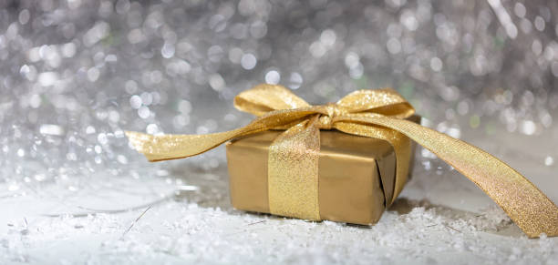 istock Christmas gift box on abstract bokeh lights and glitter background 1067162156