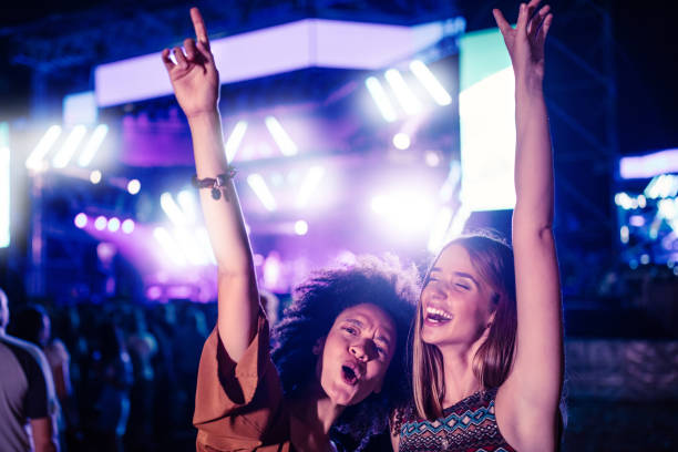 Their favourite song Two young women having fun at a music festival concert stock pictures, royalty-free photos & images