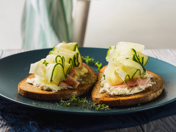 istock Rye bread toasts with cheese, ham, cucumber 1067162970
