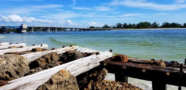 Blue Green Ocean Waters Near a Wooden Pier/Dock Relaxation ideas near calm sea waters; travel destinations longboat key stock pictures, royalty-free photos & images