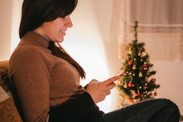 istock Woman using mobile phone at home 1067165794