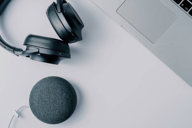 modern technologies headphones laptop and smart speaker over white background stock photo