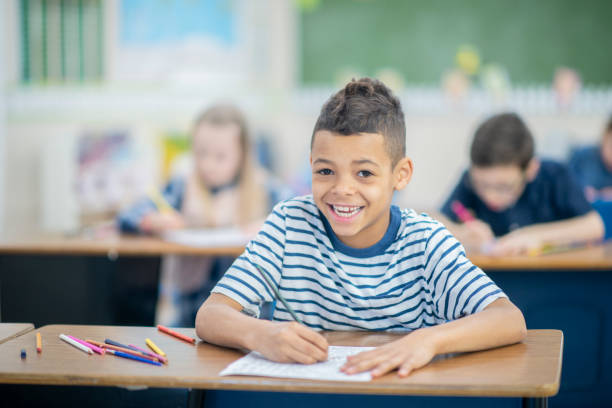 istock Cute boy sitting at his desk 1067171442