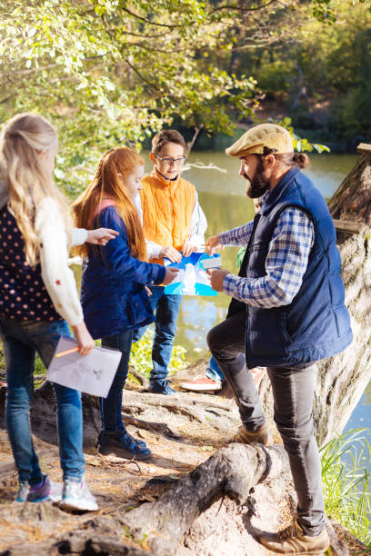 istock Nice smart children standing in front of their guide 1067174432