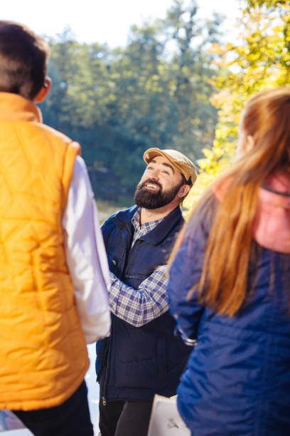 istock Positive nice man smiling to his young pupils 1067174454