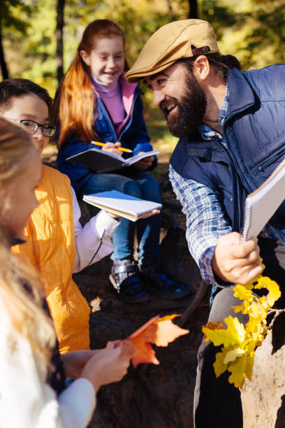 istock Positive bearded man talking to his pupils 1067174726