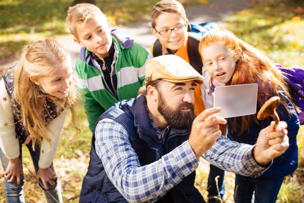 istock Serious bearded man holding a mushroom in his hand 1067177108