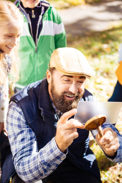 Cheerful happy man looking at the mushroom
