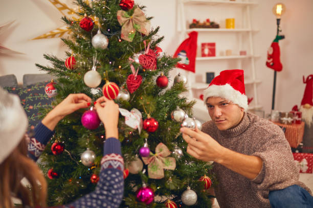 istock Happy couple decorating tree for New Year's / Christmas eve. 1067178280