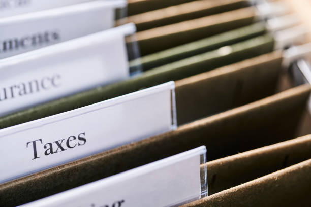 istock TAXES: Files and folders in desk drawer with labels and tabs: Home office management 1067178702