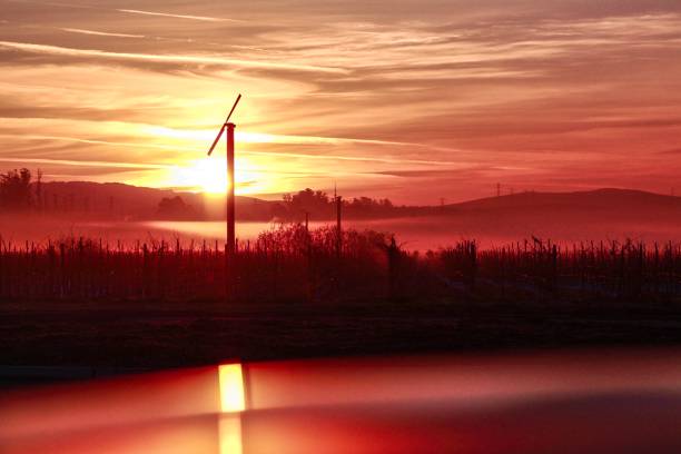 Dramatic Orange Sunrise Sunrise in Petaluma with windmill pictured. petaluma stock pictures, royalty-free photos & images