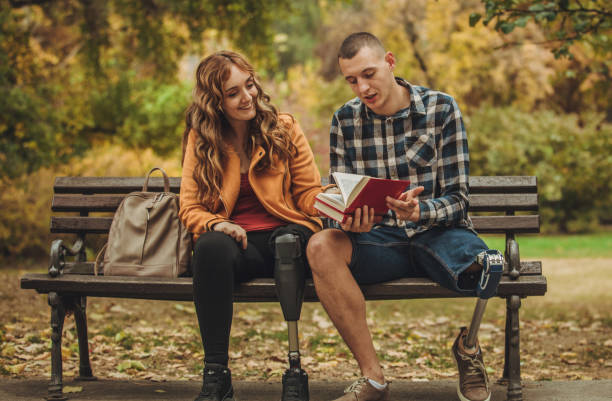 istock Disability friends sitting in park 1067181216